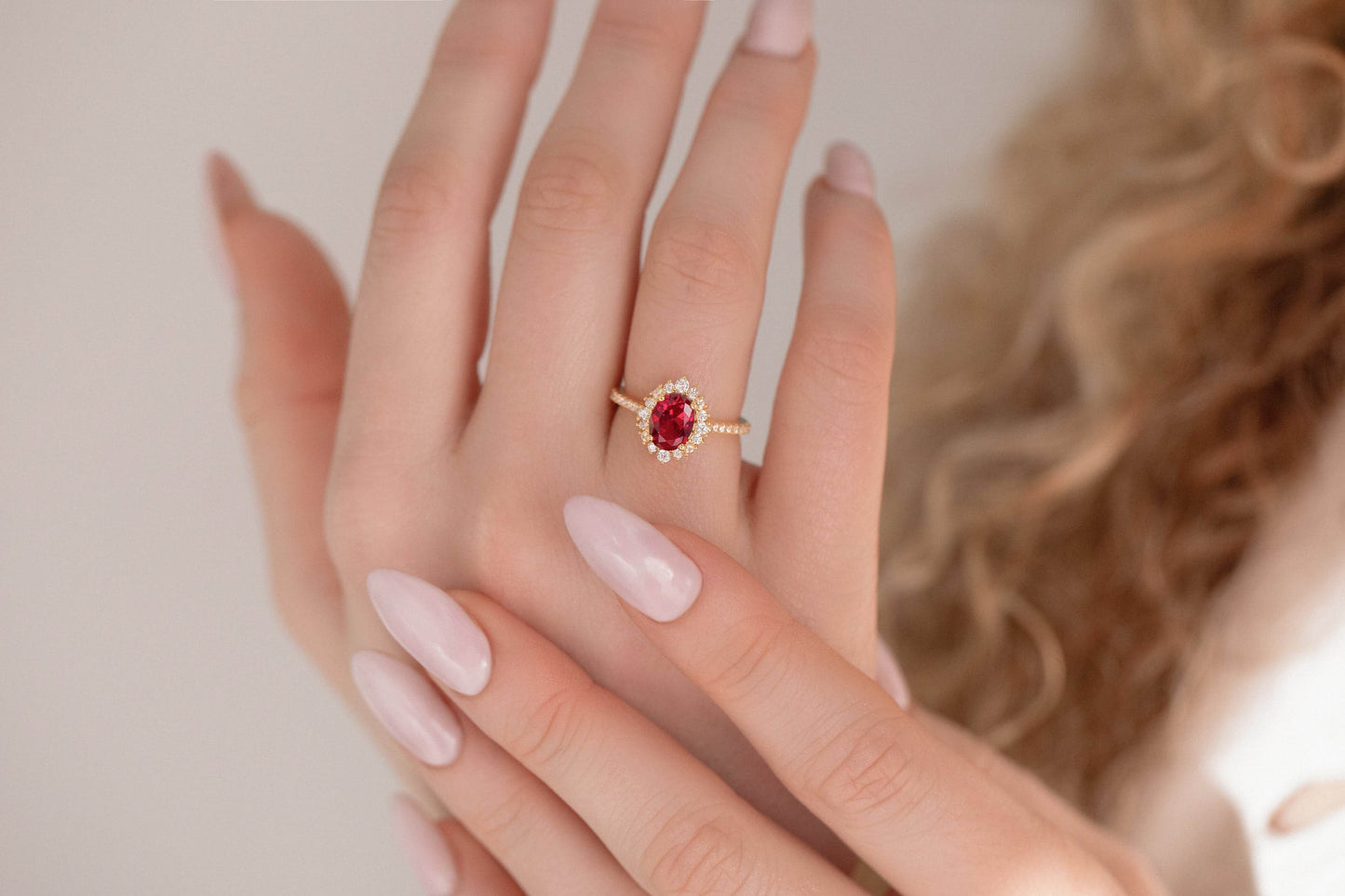 Oval cut Ruby halo ring